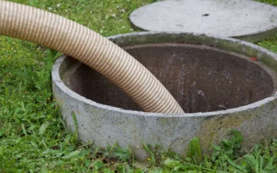 Septic tank with a hose inserted, illustrating sludge hauling for municipal wastewater systems in the Finger Lakes region.