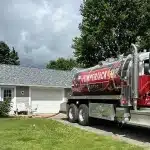 PumperJack Septic truck parked at a residential property for routine septic tank pumping service in the Finger Lakes region
