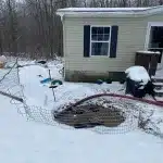 PumperJack Septic performing residential septic tank pumping in snowy winter conditions at a rural Finger Lakes home