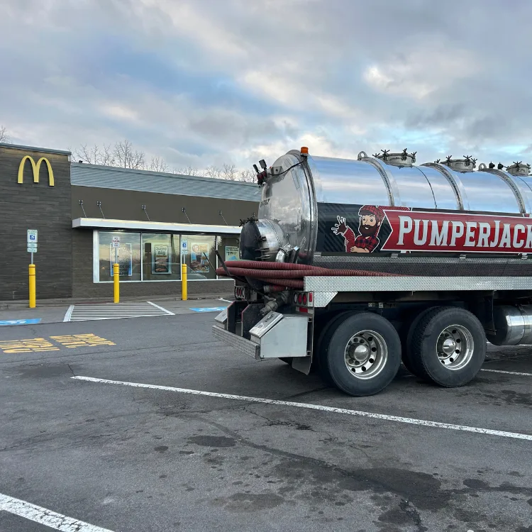 Powerful water jet cleaning a commercial sewer line during scheduled sewer clean-out service by PumperJack Septic
